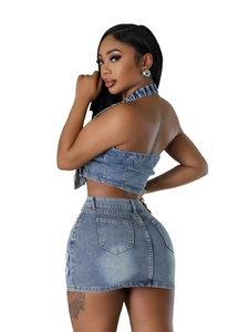 Chic two-piece denim set with halter neck crop top and mini skirt in washed blue finish