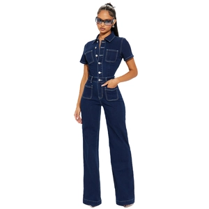 Detail of dark blue denim jumpsuit with contrast stitching and silver button closure