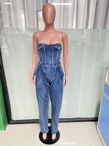 Detail of blue strapless denim jumpsuit featuring flap pockets and elastic waist design