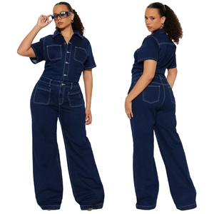 Detail view of dark blue denim jumpsuit with short sleeves and white contrast stitching