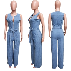 Three-way view of light blue denim jumpsuit with waist tie and front metal zipper