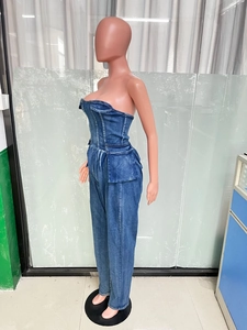Detailed side view of slim fit denim tube jumpsuit with decorative waist flap pockets