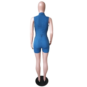 Detail of the back of a slim-fit blue denim romper with belt loops and neat stitching