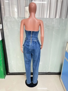 Detail view of the metal zipper closure and high-waisted pleated design on denim jumpsuit