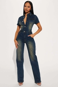 Close-up of slim-fit denim jumpsuit with lapels, metal buttons, and vintage washed texture