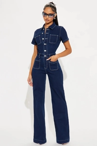 Detail view of denim jumpsuit with contrast stitching and silver metal button closure