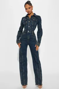 Detail of vintage blue washed denim jumpsuit with metal buttons and slim long sleeves
