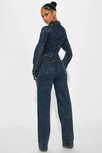 Rear view of denim jumpsuit showing snowflake wash texture and back pocket detail