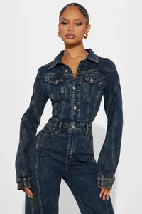 Detail shot of navy denim jumpsuit with metal button closure and classic lapel collar