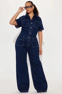 Detail of navy denim jumpsuit featuring white contrast stitching and button-up front