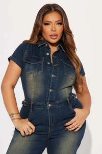 Detail of vintage washed blue denim jumpsuit with chest pockets and metal buttons