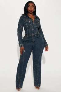 Detail of vintage washed denim jumpsuit featuring metal buttons and long sleeves