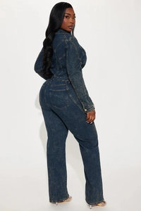 Detail view of the back pockets and structured seams on this washed denim jumpsuit