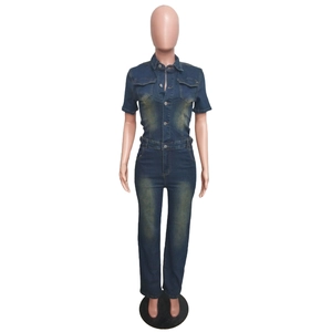 Detailed front view of slim fit dark blue washed denim jumpsuit with chest pockets