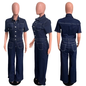 Detail of dark blue denim jumpsuit with short sleeves and white contrast stitching detail