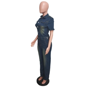 Side view of dark blue denim jumpsuit with short sleeves and metal belt on a mannequin