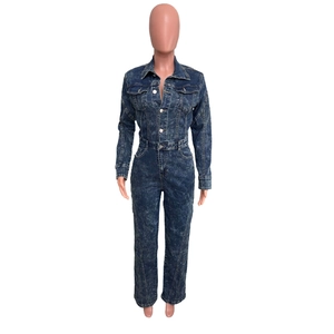 Detail of acid wash denim jumpsuit featuring long sleeves and metal button closure