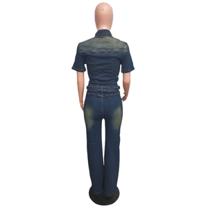 Rear view of slim fit dark blue denim jumpsuit with vintage washed effect on the back