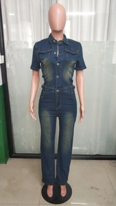 Detail of vintage dark blue denim jumpsuit featuring chest flap pockets and button closure