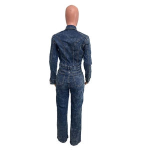 Back view of long sleeve denim jumpsuit featuring acid wash finish and straight leg fit