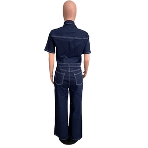 Detail view of dark wash denim jumpsuit showing contrast stitching and large back pockets