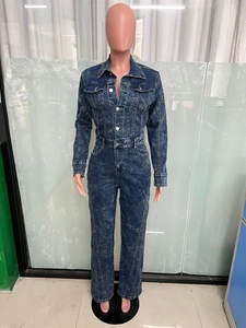 Close-up of acid wash denim jumpsuit featuring silver buttons and metal hardware details