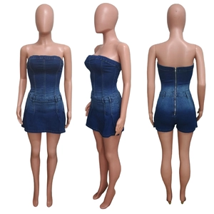 Detail view of the zipper back closure and elastic denim fabric on a tube top romper