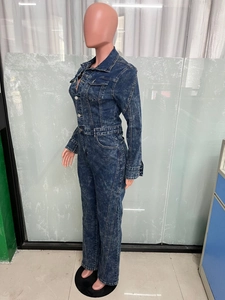 Detail of vintage blue denim jumpsuit with acid wash finish and long sleeves design
