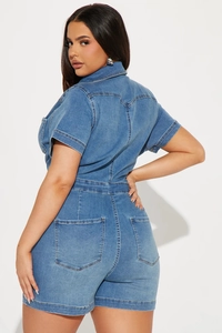Detail shot of the back pockets and high-waist cut of the washed denim romper