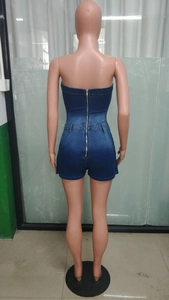 Detail view of denim strapless romper with back zipper closure and slim fit silhouette