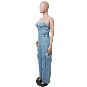 Détail d'une combinaison bustier en jean avec poches cargo et fermeture à boucle métal