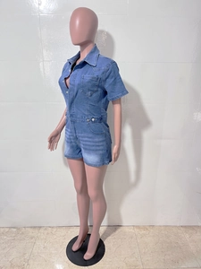 Detail view of denim romper showing turn-down collar and chest pockets on mannequin