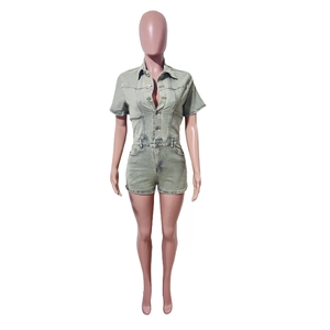 Detail showing lapel collar, button-down front and chest pockets on light green denim romper
