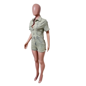 Detail of light green washed denim romper featuring a button-down front and lapel collar