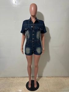 Détail d'un combishort en jean bleu foncé avec effet délavé et poches avant boutonnées