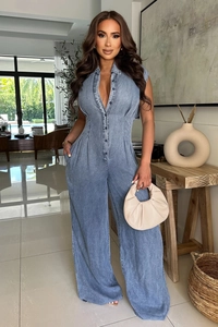 Detail of light blue sleeveless denim jumpsuit with metallic buttons and slim waist fit