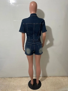 Détail d'un combishort en jean montrant les poches arrière et la texture délavée du tissu