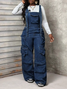 Detailed view of dark blue denim overalls with large cargo pockets and adjustable hooks