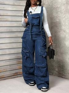 Detailed view of dark blue denim overalls with multiple utility pockets and wide leg cut