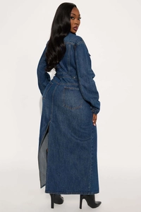 Detail of dark blue denim trench coat featuring back slit and functional rear pockets