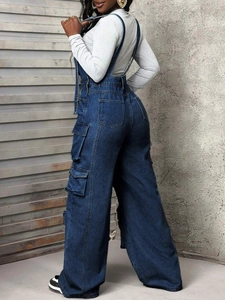 Detail of loose fit wide leg denim overalls with side cargo pockets for women