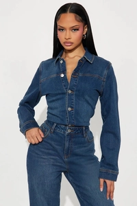 Vue détaillée de la texture du tissu de la combinaison en jean et boutons en métal