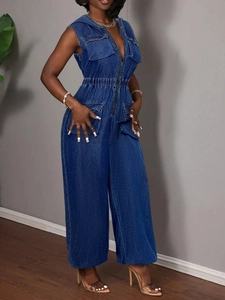 Detail of dark blue hooded denim jumpsuit featuring front zipper and elastic waist