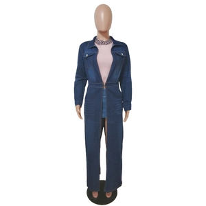 Detail of a long-sleeved dark blue denim coat with classic collar and chest pockets