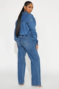 Detail view of high-density denim jumpsuit with loose shirt and wide-leg trousers