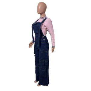 Side view detail of loose-fit denim dungarees with pink knit top and utility cargo pockets
