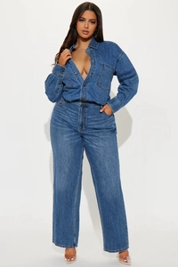 Detail of dark blue denim jumpsuit with long sleeves, high-waist design and street style texture