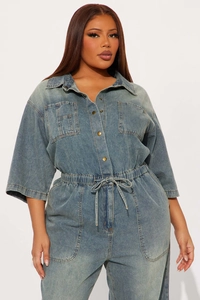 Detailed view of women's denim jumpsuit featuring a classic collar and metal buttons