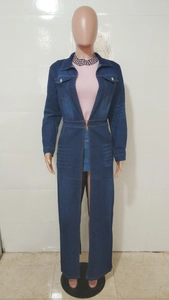 Detail of long denim coat featuring utility chest pockets and tailored waist stitching