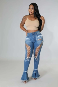 Detail der Schlagjeans mit Schnür-Ausschnitten und markantem ausgefranstem Saum am Bein
